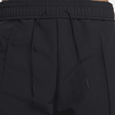 Nike Nike Sportswear Everything WovensPantalón de talle medio con dobladillo abierto - Mujer COMPRAR AHORA