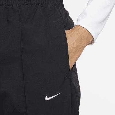 Nike Nike Sportswear Everything WovensPantalón de talle medio con dobladillo abierto - Mujer COMPRAR AHORA